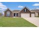 Charming brick home featuring a manicured lawn, a two-car garage, and a welcoming front entrance at 3799 Hoosier Down Dr, Bargersville, IN 46106