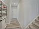 Inviting hallway featuring neutral paint, vinyl flooring, and a staircase to the upper level at 3799 Hoosier Down Dr, Bargersville, IN 46106