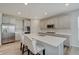 Spacious kitchen with gray cabinets, a large center island, and stainless steel appliances at 3799 Hoosier Down Dr, Bargersville, IN 46106