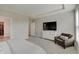 Comfortable main bedroom features a large TV, neutral walls, and a cozy reading nook at 3799 Hoosier Down Dr, Bargersville, IN 46106