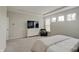 Bright main bedroom boasts tray ceilings, three windows, a TV, and a cozy chair at 3799 Hoosier Down Dr, Bargersville, IN 46106