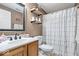 Neutral bathroom featuring decorative shelves and a shower curtain at 4223 W State Road 234, McCordsville, IN 46055