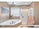 Bathroom boasts a corner soaking tub, separate shower, mosaic tile detail and modern lighting at 4223 W State Road 234, McCordsville, IN 46055