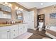 Spacious bathroom features double vanity, a soaking tub with decorative tile, and modern fixtures at 4223 W State Road 234, McCordsville, IN 46055