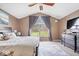 Bright bedroom features large windows, vaulted ceiling, and neutral color palette at 4223 W State Road 234, McCordsville, IN 46055