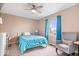Bright bedroom with blue accents, comfortable chair, and natural light at 4223 W State Road 234, McCordsville, IN 46055