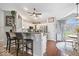 Open-concept kitchen with breakfast bar, stainless appliances, and hardwood flooring at 4223 W State Road 234, McCordsville, IN 46055