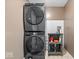 Modern laundry room boasts stacked washer/dryer and stylish storage and decor at 4223 W State Road 234, McCordsville, IN 46055
