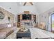 Inviting living room with a stone fireplace, built-in shelves, and comfortable seating, perfect for relaxing and entertaining at 4223 W State Road 234, McCordsville, IN 46055