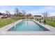 Sparkling in-ground pool with surrounding patio, complemented by outdoor furniture and a serene backyard setting at 4223 W State Road 234, McCordsville, IN 46055
