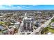 Straight on shot of condo building with surrounding streets, homes, and green trees at 435 Virginia Ave # 402, Indianapolis, IN 46203
