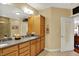 Bright bathroom features double sinks, granite countertops, wood cabinets, and a tiled shower at 435 Virginia Ave # 402, Indianapolis, IN 46203