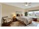 Bright bedroom with a ceiling fan, natural light, a decorative chair, and a comfortable bed at 435 Virginia Ave # 402, Indianapolis, IN 46203