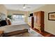 Bright bedroom featuring a large window, a ceiling fan, and ample space with wooden furniture at 435 Virginia Ave # 402, Indianapolis, IN 46203