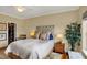 Comfortable bedroom with a ceiling fan, natural light, a decorative chair, and a comfortable bed at 435 Virginia Ave # 402, Indianapolis, IN 46203