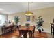 Dining room with hardwood floors, large potted plants, and modern light fixture at 435 Virginia Ave # 402, Indianapolis, IN 46203