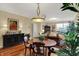 Dining room with wood floors, elegant lighting, and table with seating for four at 435 Virginia Ave # 402, Indianapolis, IN 46203