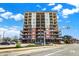 Beautiful condo building with brick and light colored siding, and balconies, under a partly cloudy sky at 435 Virginia Ave # 402, Indianapolis, IN 46203