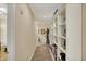 Well-lit hallway featuring tan walls, built-in shelving, porcelain decorations and decoratively framed wall art at 435 Virginia Ave # 402, Indianapolis, IN 46203