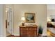 Hallway featuring a wooden dresser, painting, and doorway views into other rooms of the house at 435 Virginia Ave # 402, Indianapolis, IN 46203