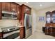 Well-equipped kitchen featuring stainless steel appliances and granite countertops with brown cabinets at 435 Virginia Ave # 402, Indianapolis, IN 46203