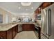 Open kitchen design with stainless steel appliances, granite countertops, and dark brown cabinets at 435 Virginia Ave # 402, Indianapolis, IN 46203