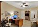Comfortable office space with built-in desk, ceiling fan, and access to additional room space at 435 Virginia Ave # 402, Indianapolis, IN 46203