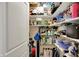 Pantry room with multiple shelves packed with a variety of household goods and supplies at 435 Virginia Ave # 402, Indianapolis, IN 46203