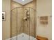 Bathroom featuring a corner shower with a sleek glass door, tiled walls, and neutral colors at 435 Virginia Ave # 402, Indianapolis, IN 46203