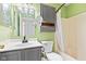 Bathroom features a shower/tub with a shower curtain, toilet, vanity, mirror, and built-in cabinet at 448 Yorktown Ln, Avon, IN 46123