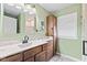 Updated bathroom with wood cabinets, modern sink and neutral walls at 448 Yorktown Ln, Avon, IN 46123