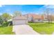 Spacious two-car garage with a driveway, set against a backdrop of a well-manicured lawn at 448 Yorktown Ln, Avon, IN 46123