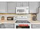 Bright kitchen featuring modern appliances and gray cabinetry at 448 Yorktown Ln, Avon, IN 46123