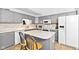 Kitchen features stainless steel appliances, an island with seating, and tile backsplash at 448 Yorktown Ln, Avon, IN 46123