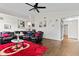 Spacious living room with hardwood floors, a modern ceiling fan and plush seating. Great for entertaining at 448 Yorktown Ln, Avon, IN 46123