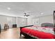 Spacious main bedroom featuring hardwood floors, a ceiling fan, and natural light from the windows at 448 Yorktown Ln, Avon, IN 46123