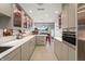 A stylish bar featuring gray cabinets, quartz countertops, an oven, and a view of the open floor plan at 4561 Coles Dr, Columbus, IN 47201