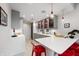 Contemporary bar area with sleek gray cabinets, glassware display, and modern lighting fixtures at 4561 Coles Dr, Columbus, IN 47201