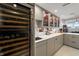 The modern bar area features a wine fridge, sleek gray cabinets, and a functional sink area at 4561 Coles Dr, Columbus, IN 47201