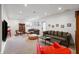 Spacious finished basement with comfortable seating, entertainment area, and neutral carpeting at 4561 Coles Dr, Columbus, IN 47201