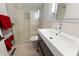 Bathroom featuring sleek white vanity, glass-enclosed shower, and modern fixtures at 4561 Coles Dr, Columbus, IN 47201
