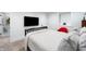 Well-lit bedroom features neutral walls, a black paneled headboard, and an adjacent doorway at 4561 Coles Dr, Columbus, IN 47201