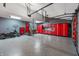 Spacious garage with epoxy floors, custom cabinetry, and a motorcycle at 4561 Coles Dr, Columbus, IN 47201