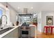 Well-lit kitchen featuring modern appliances, sleek cabinetry, and a view into the living space at 4561 Coles Dr, Columbus, IN 47201