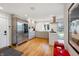 Bright kitchen with stainless steel appliances, wood floors, and a view to the outside patio at 4561 Coles Dr, Columbus, IN 47201