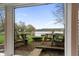 Scenic lake view through a window with lawn chairs and a clear sky at 4561 Coles Dr, Columbus, IN 47201