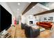 Bright, open living room features wood floors, fireplace, exposed beam and stylish furnishings at 4561 Coles Dr, Columbus, IN 47201