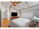 Bedroom with a four poster bed, wood floors, and a TV on a wooden dresser at 4561 Coles Dr, Columbus, IN 47201
