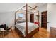 Bedroom with a four poster bed, hardwood floors, and natural light from a window at 4561 Coles Dr, Columbus, IN 47201