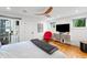 Bedroom with wood floors, ceiling fan, TV, access to a screened porch and a lake view at 4561 Coles Dr, Columbus, IN 47201